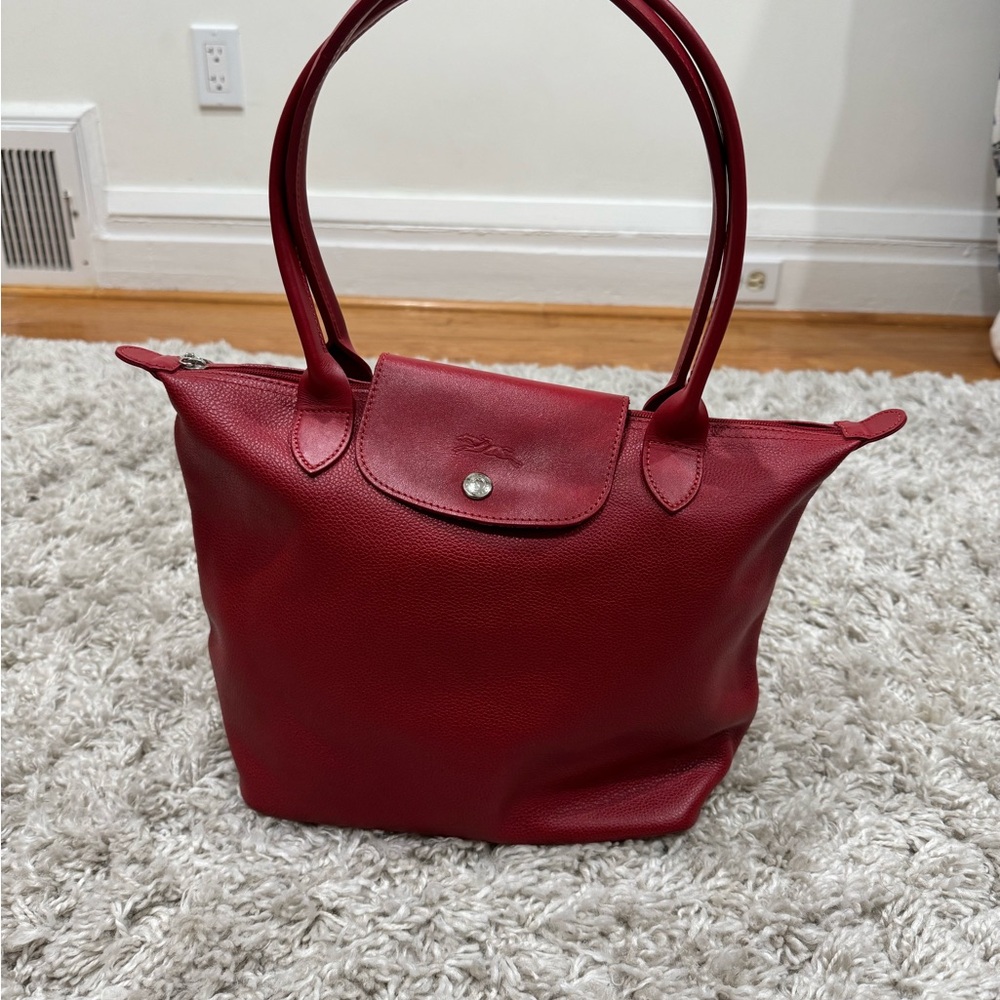 Longchamp Leather Cherry Red Tote Bag. Ling strap can wear over the shoulder.